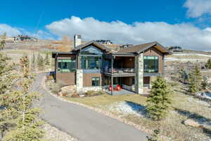 Rear view of property featuring a sunroom and a balcony