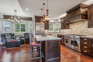 Updated kitchen with high end appliances, granite counter tops, wood floor and plantation shutters