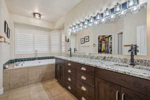 Primary bathroom with separate shower, jetted tub, and double vanity