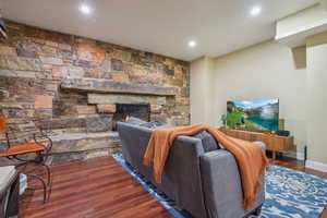 Family room on lower level with wood burning fire place, 9' ceilings and LVT flooring.