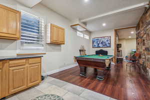 Lower level walkout with space for game tables, LVT flooring, plantation shutters, beautiful stone work.