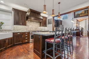 Updated kitchen with an apron sink, granite counter tops, wood floor and plantation shutters.