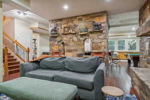 Family room on lower level with wood burning fire place, 9' ceilings and LVT flooring.