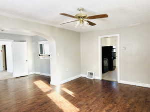 Empty room featuring wood-type flooring, a textured ceiling, and ceiling fan