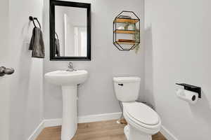 Bathroom with toilet and hardwood / wood-style floors