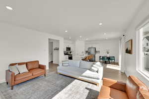 Living room with light hardwood / wood-style floors and sink