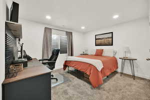 Bedroom with light colored carpet