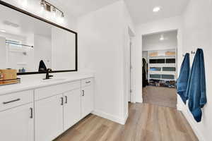 Bathroom with vanity and hardwood / wood-style floors