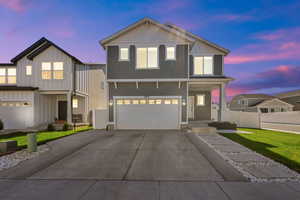 View of front of home featuring a lawn and a garage