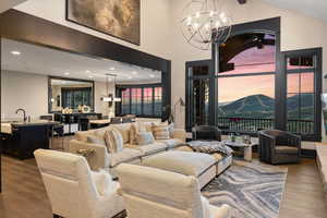 Living room featuring an inviting chandelier, a mountain view, sink, and hardwood / wood-style flooring