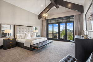 Bedroom with access to outside, high vaulted ceiling, a notable chandelier, and carpet floors