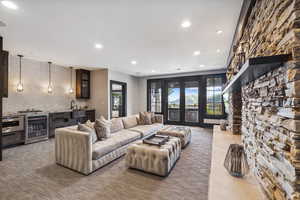 Living room with french doors, wine cooler, and carpet floors