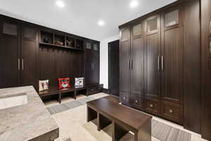 Mudroom with sink and light tile patterned floors