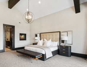 Bedroom with beamed ceiling, carpet, a notable chandelier, and high vaulted ceiling