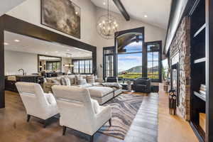 Living room with hardwood / wood-style floors, beam ceiling, and a healthy amount of sunlight