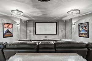 Cinema featuring an inviting chandelier