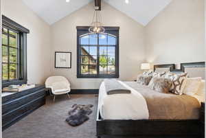 Bedroom featuring lofted ceiling and multiple windows