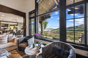 Living room featuring wood-type flooring, high vaulted ceiling, and a mountain view