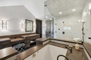 Bathroom with plus walk in shower, vanity, and lofted ceiling