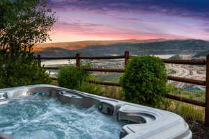 Exterior space with a mountain view and a hot tub