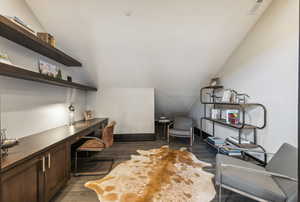 Office featuring dark hardwood / wood-style flooring and lofted ceiling