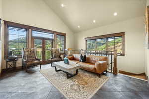 Living room with high vaulted ceiling and a wealth of natural light