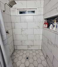 Bathroom featuring curtained shower and tile walls