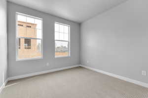 Carpeted empty room featuring a healthy amount of sunlight