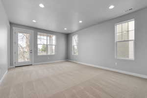 Carpeted spare room with a textured ceiling