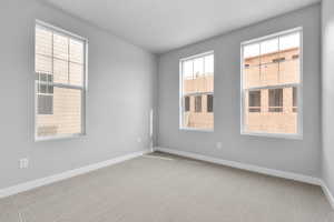 Spare room featuring light colored carpet