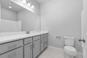 Bathroom with tile patterned floors, vanity, and toilet