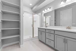 Bathroom featuring vanity, an enclosed shower, and tile patterned floors