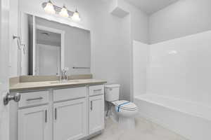 Full bathroom with vanity, bathing tub / shower combination, and toilet