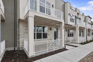 Exterior space featuring a porch and a balcony