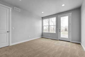 Carpeted empty room with a textured ceiling