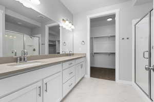 Bathroom featuring walk in shower and vanity