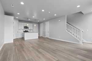 Unfurnished living room with light hardwood / wood-style flooring