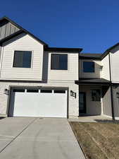 View of front facade featuring a garage and a front yard