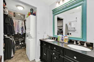 ADU Bathroom featuring stacked washer and clothes dryer and vanity