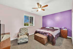 Carpeted bedroom with ceiling fan