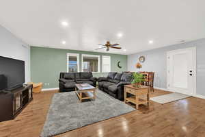 Living room with light hardwood / wood-style flooring and ceiling fan