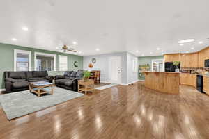 Living room featuring light wood-type flooring and ceiling fan