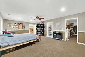 Carpeted bedroom with ceiling fan