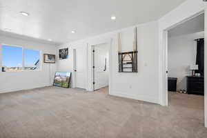 Unfurnished bedroom with light colored carpet