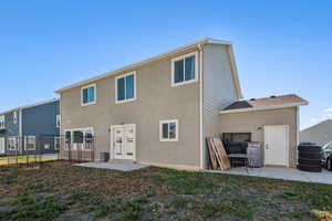 Back of house with a lawn, french doors, and a patio area