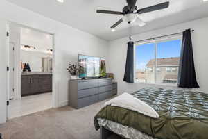 Carpeted bedroom with connected bathroom, a textured ceiling, and ceiling fan