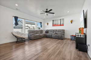 Living room featuring hardwood / wood-style floors and ceiling fan