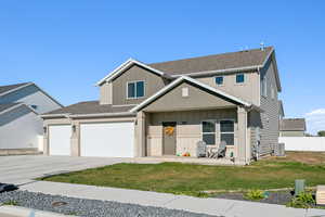 View of front of house with central AC unit and a front yard