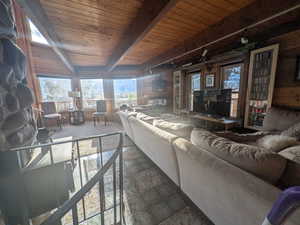 Living room with beamed ceiling and wood ceiling