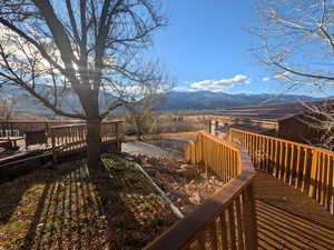 Wooden terrace featuring a mountain view